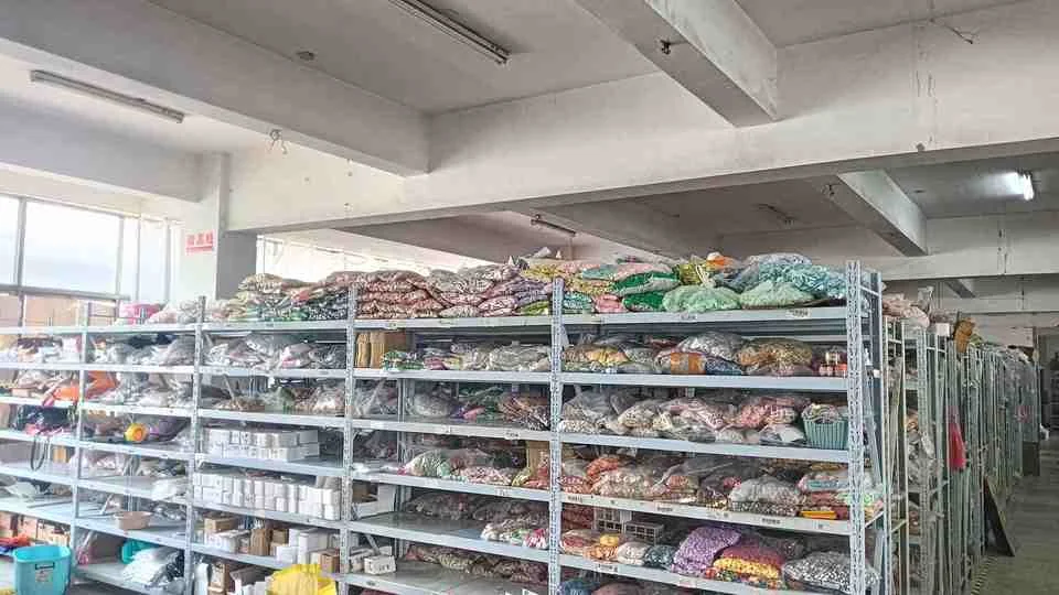 Warehouse shelves holding sorted craft components and stock materials