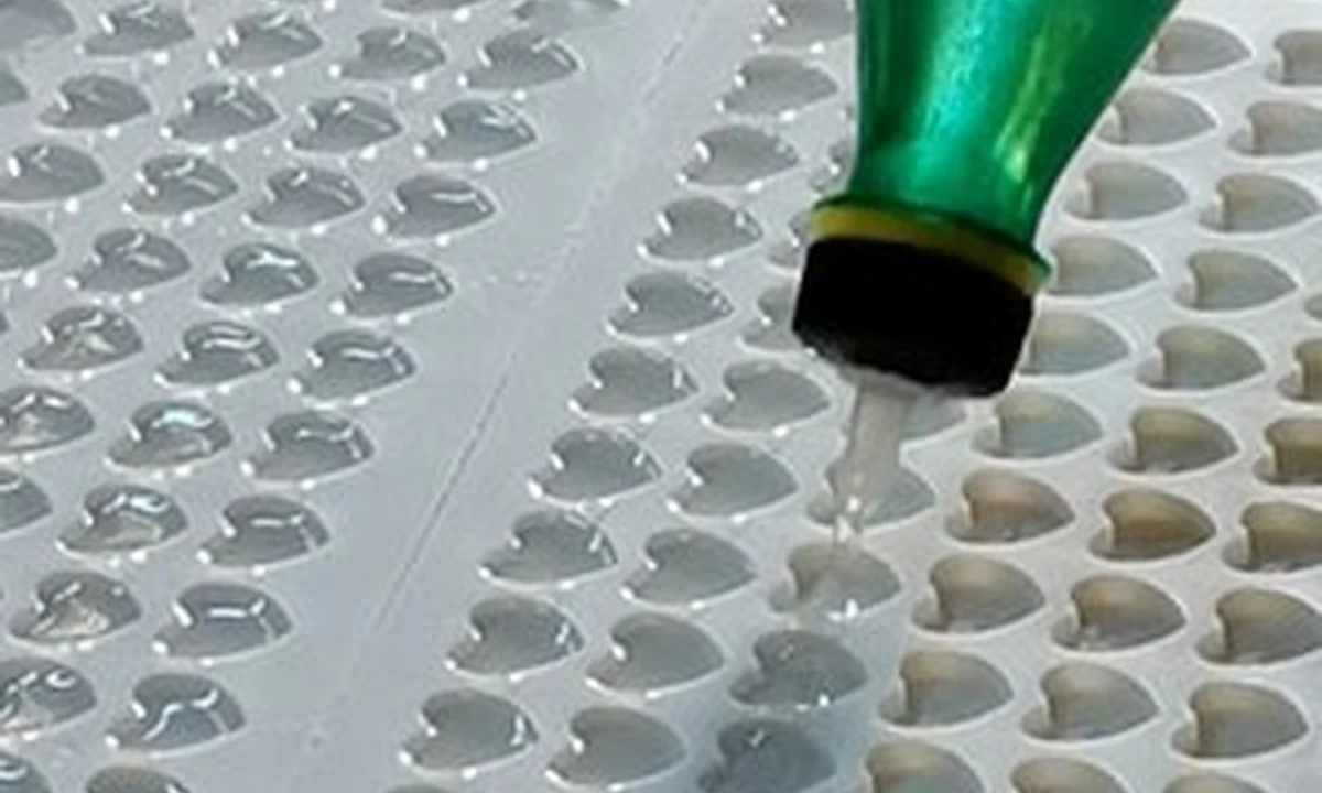 Production material being carefully poured into a multi-cavity mold